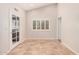 Open living room features tiled floors, high ceilings, and natural light at 10244 N 65Th Ln, Glendale, AZ 85302
