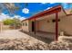 Covered patio featuring brick flooring, exterior bench and red beams at 10244 N 65Th Ln, Glendale, AZ 85302