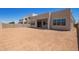 Spacious backyard featuring modern home architecture with large windows and a covered patio, perfect for outdoor living at 10332 E Utah Ave, Mesa, AZ 85212