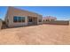 View of backyard featuring a modern home design and ample space awaiting personalization and landscaping under a clear sky at 10332 E Utah Ave, Mesa, AZ 85212