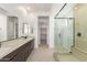 Modern bathroom featuring dual sinks, a walk-in shower, and sleek fixtures at 10332 E Utah Ave, Mesa, AZ 85212