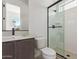 Contemporary bathroom with a modern vanity, matte black faucet, and a glass-enclosed shower at 10332 E Utah Ave, Mesa, AZ 85212