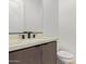 This bathroom features a modern sink with quartz countertop and wood-grain vanity at 10332 E Utah Ave, Mesa, AZ 85212