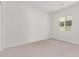 Well-lit bedroom with neutral carpet and a large window at 10332 E Utah Ave, Mesa, AZ 85212