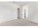Bright bedroom with neutral carpet and white walls featuring doorways to other rooms at 10332 E Utah Ave, Mesa, AZ 85212