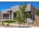 Modern home featuring desert landscaping, a gray two-car garage, and a geometric walkway at 10332 E Utah Ave, Mesa, AZ 85212