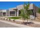 Modern home featuring desert landscaping, a gray two-car garage, and a geometric walkway at 10332 E Utah Ave, Mesa, AZ 85212