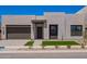 Contemporary home with a two-car garage, desert landscaping, and a clean, modern facade at 10332 E Utah Ave, Mesa, AZ 85212