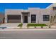Contemporary home with a two-car garage, desert landscaping, and a clean, modern facade at 10332 E Utah Ave, Mesa, AZ 85212