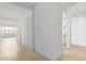 Bright hallway with neutral tile flooring, white walls, and recessed lighting at 10332 E Utah Ave, Mesa, AZ 85212