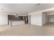Spacious living room leading into a kitchen area, featuring light tile flooring and recessed lighting at 10332 E Utah Ave, Mesa, AZ 85212