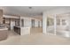 Spacious kitchen and living room open floor plan bathed in light with a sliding glass door to the patio at 10332 E Utah Ave, Mesa, AZ 85212