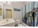 Bright bathroom featuring a shower-tub combination, turtle shower curtain, and decorative mirror at 11156 E Lost Canyon Ct, Gold Canyon, AZ 85118