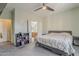 Inviting bedroom featuring carpet flooring, a ceiling fan, and an en-suite bathroom with well designed storage spaces at 11156 E Lost Canyon Ct, Gold Canyon, AZ 85118