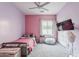Cozy bedroom featuring a plush bed, ceiling fan, and mounted TV for relaxing evenings at 11156 E Lost Canyon Ct, Gold Canyon, AZ 85118