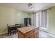 Spacious kitchen with a wooden island, dining area, tile flooring, and a black refrigerator and patio access at 11156 E Lost Canyon Ct, Gold Canyon, AZ 85118