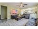 Open-concept living room featuring tile flooring, neutral paint, a ceiling fan, and access to the kitchen at 11156 E Lost Canyon Ct, Gold Canyon, AZ 85118