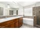 Bright bathroom features double sinks, a separate tub, and a tiled glass shower enclosure at 11834 N 147Th Ln, Surprise, AZ 85379