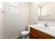Well-lit powder room features a modern vanity, toilet, and neutral finishes for a clean and functional space at 11834 N 147Th Ln, Surprise, AZ 85379