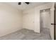 This bedroom offers neutral colors, carpet flooring, a ceiling fan and access to an additional room at 11834 N 147Th Ln, Surprise, AZ 85379