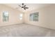 Spacious bedroom with plush carpeting, ceiling fan, and windows providing natural light at 11834 N 147Th Ln, Surprise, AZ 85379