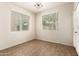 Sunlit dining area with stylish light fixture, ceramic tile flooring, and two large windows at 11834 N 147Th Ln, Surprise, AZ 85379