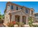 Charming two-story home showcasing desert landscaping and an inviting covered entryway at 11834 N 147Th Ln, Surprise, AZ 85379
