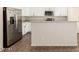 Contemporary kitchen featuring a stainless steel refrigerator and a sleek center island at 11834 N 147Th Ln, Surprise, AZ 85379