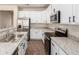 Well-equipped kitchen featuring granite countertops, stainless steel appliances, and modern white cabinetry at 11834 N 147Th Ln, Surprise, AZ 85379