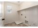 A utility area with tile floors, a window, and connections for laundry appliances at 11834 N 147Th Ln, Surprise, AZ 85379