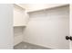 Walk-in closet features carpeted flooring and built-in shelving for organized storage of clothing and accessories at 11834 N 147Th Ln, Surprise, AZ 85379