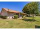 Spacious backyard with mature landscaping, including manicured bushes and lush green grass at 129 Leisure World --, Mesa, AZ 85206