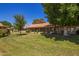 Expansive backyard featuring lush green grass and mature trees, perfect for outdoor enjoyment at 129 Leisure World --, Mesa, AZ 85206