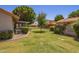 Large backyard with a well-maintained lawn, mature landscaping, and comfortable privacy at 129 Leisure World --, Mesa, AZ 85206
