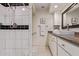 Bathroom vanity with granite counters and a shower with black and white tile at 129 Leisure World --, Mesa, AZ 85206