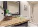 Bathroom featuring a glass vessel sink atop a granite counter and a framed mirror at 129 Leisure World --, Mesa, AZ 85206