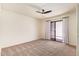 Neutral carpeted bedroom with a sliding glass door to the outside at 129 Leisure World --, Mesa, AZ 85206
