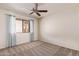 Bedroom with neutral carpet, white walls, and a window with blue curtains at 129 Leisure World --, Mesa, AZ 85206
