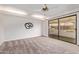A bedroom with a sliding glass door and neutral-colored carpet and white walls at 129 Leisure World --, Mesa, AZ 85206