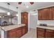 Open kitchen with wood cabinets and granite countertops, seamlessly flowing into the living area at 129 Leisure World --, Mesa, AZ 85206