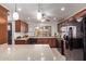 Well-lit kitchen featuring granite countertops, wood cabinets, and stainless steel appliances at 129 Leisure World --, Mesa, AZ 85206