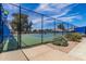 Well-maintained tennis court with secure fencing, landscaping, and clear signage for community use at 129 Leisure World --, Mesa, AZ 85206