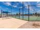 Well-maintained tennis courts with blue playing surfaces and shaded spectator seating at 129 Leisure World --, Mesa, AZ 85206