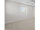 Neutral carpeted bedroom with a large window and a ceiling fan for added comfort at 13473 N 158Th Ave, Surprise, AZ 85379