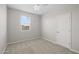 Neutral bedroom showcasing plush carpet, a window, and a closet door at 13473 N 158Th Ave, Surprise, AZ 85379