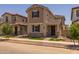 Charming two-story home with neutral stucco, landscaped front yard, covered entrance and tile roof at 13473 N 158Th Ave, Surprise, AZ 85379