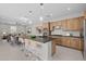 Open-concept kitchen with island seating, stainless steel appliances, and wood cabinets at 13473 N 158Th Ave, Surprise, AZ 85379