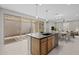 Open kitchen featuring island with sink, seating, and sliding doors to the outdoor living space at 13473 N 158Th Ave, Surprise, AZ 85379