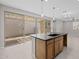 Open-concept kitchen with a center island, dark countertops, and sliding glass doors to patio at 13473 N 158Th Ave, Surprise, AZ 85379