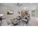 Spacious living room with neutral tones, tile floors, ceiling fan and bright window at 13473 N 158Th Ave, Surprise, AZ 85379
